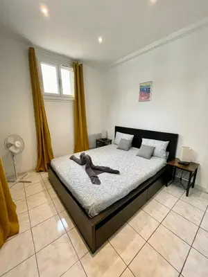 a bedroom with a bed with a teddy bear on it at Joli appartement spacieux à 3 min à pied de la mer in Nice