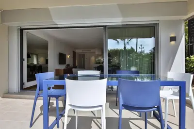 a dining room with blue tables and white chairs at Sublime Appartement Promenade des Anglais RDJ in Nice