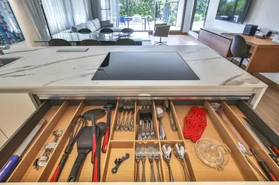 a drawer in a counter with cooking utensils at Sublime Appartement Promenade des Anglais RDJ in Nice