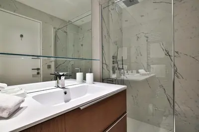 a bathroom with a sink and a glass shower at Sublime Appartement Promenade des Anglais RDJ in Nice