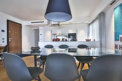 a dining room with a glass table and chairs at Sublime Appartement Promenade des Anglais (2) in Nice