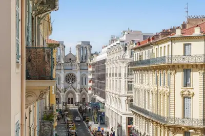 a living room with a couch and a table at Nice Renting - NOTRE DAME - Cosy Loft Perfect View on the roofs in Nice
