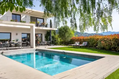 a house with a swimming pool in the yard at Villa Les Sources VI4245 By Riviera Holiday Homes in Nice