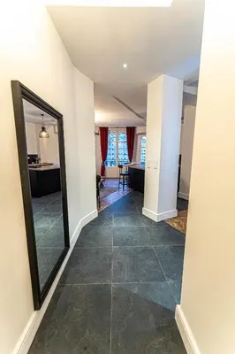 a hallway with a mirror and a living room at Jacuzzi-Nice quartier des musiciens-Loft in Nice