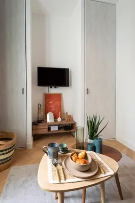a living room with a table with a bowl of food on it at Superbe studio Plage/Promenade des Anglais 105 in Nice