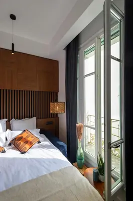 a bedroom with a bed and a large window at Superbe studio Plage/Promenade des Anglais 105 in Nice