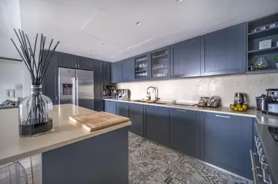 a kitchen with blue cabinets and a counter top at Superbe appartement Cap de nice in Nice