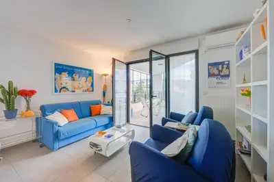 a living room with blue couches and a table at Appartement Liberation in Nice
