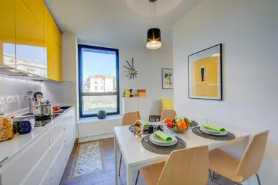 a kitchen and dining room with a table and chairs at Appartement Liberation in Nice