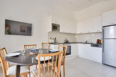 a kitchen and dining room with a table and chairs at Mer et Soleil - Carré d'or - 4 piéces - Centre ville - Plages à 300 m in Nice