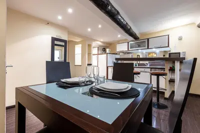 a kitchen and dining room with a table and chairs at Atypical Cozy 1 Bdr Old Town in Nice