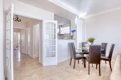 a dining room and kitchen with a table and chairs at Horizon Blue Lux Apartment in Nice