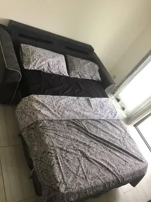 a bed in a room with two pillows on it at Studio meublé. Proche mer et centre ville in Nice