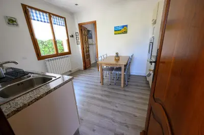 a kitchen with a sink and a table with a tableablish at LA CASA in Cagnes-sur-Mer