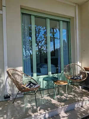 a living room with a yellow couch and a kitchen at Garden Atlantide Promenade in Nice