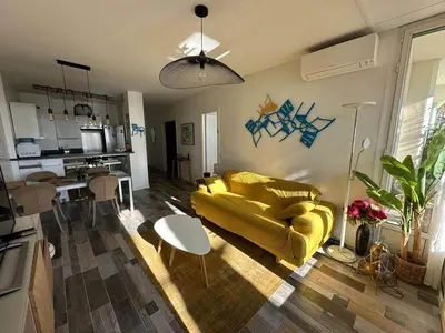 a kitchen with a counter and some stools at Garden Atlantide Promenade in Nice