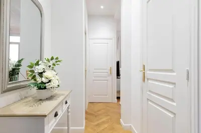 a bathroom with a mirror and a vase of flowers on a counter at Promenade, 2pièces chic et clim avec terrasse Location éligible au Bail Mobilité Mobility Lease in Nice