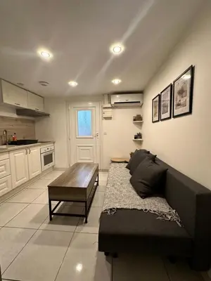 a living room with a couch and a table at Jolie appartement Nice proche mer et aéroport Une chambre plus salon avec cuisine in Nice