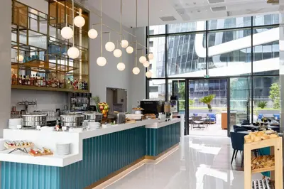 a restaurant with a counter in a building at Sheraton Nice in Nice