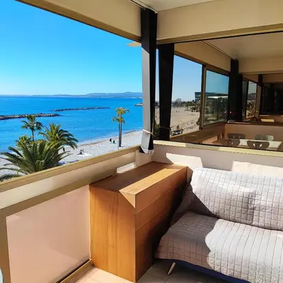 a bedroom with a view of the beach at Grand studio bord de mer- accès direct aux plages in Saint-Laurent-du-Var