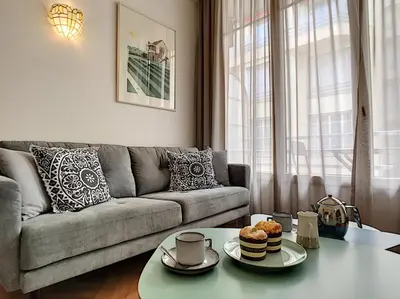 a living room with a couch and a table with cupcakes on it at Nestor&Jeeves - MARIA BEACH - Central - By sea in Nice