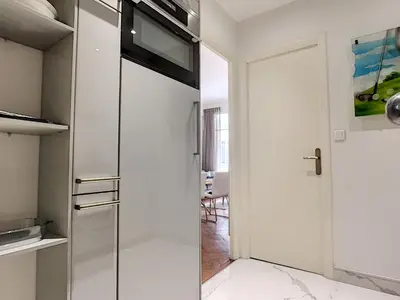 a kitchen with a glass door leading to a dining room at Nestor&Jeeves - MARIA BEACH - Central - By sea in Nice