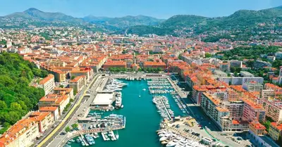 an aerial view of a city with boats in a harbor at Le Delfino PORT DE NICE in Nice