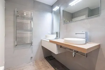 a white bathroom with a sink and a mirror at Villefranche Sur Mer:Appartement-villa, Vue mer, jardin, parking. in Villefranche-sur-Mer