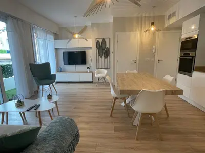 a kitchen and living room with a table and chairs at Reine Marie :Top floor Carré d'or avec accès direct à la mer in Nice