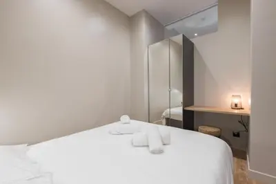 a bedroom with a white bed with towels on it at Charming 2 Bdr Old Town in Nice