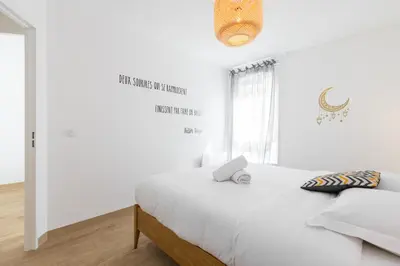 a white bedroom with a bed and a window at Large 2 Bdr at Nice Port in Nice