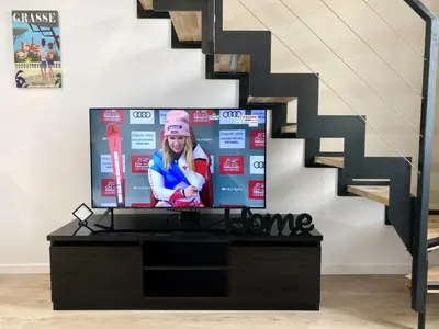 a flat screen tv sitting next to a staircase at Central Lamartine Flat - Brand New in Nice