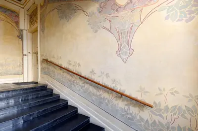 a staircase in a building with a painting on the wall at Maison Bianchi - Old Town Flower market in Nice