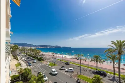 a view of the beach and the ocean from a building at MY CASA - PROM 163 - 2 rooms with terrace Promenade des Anglais in Nice