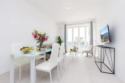 a white dining room with a table and chairs at MY CASA - PROM 163 - 2 rooms with terrace Promenade des Anglais in Nice