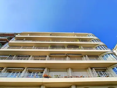 a tall white building with balconies on it at Nestor&Jeeves - BLUE PROMENADE - Sea front - Central - Luxe in Nice