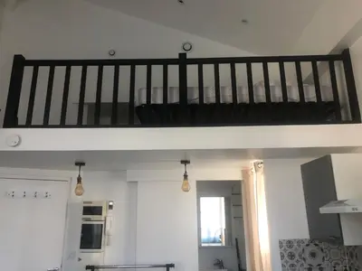 a loft bed in a living room with a staircase at Charmant studio proche mer in Nice