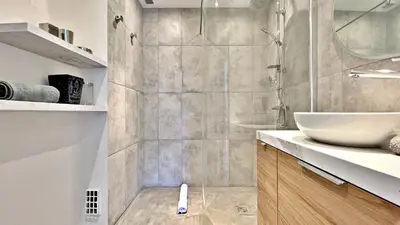 a bathroom with a sink and a glass shower at LA LANTERNE in Nice