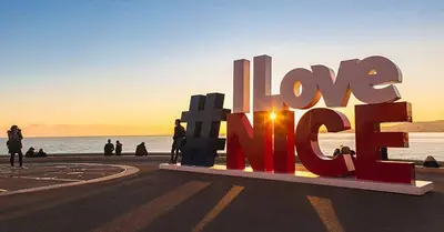 a large sign that says love eat on the beach at LA LANTERNE in Nice