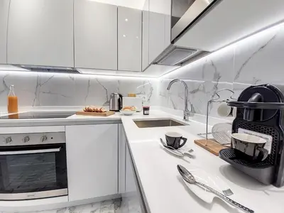 a white kitchen with white cabinets and a sink at Nestor&Jeeves - FLOREAL BEACH - Central - Close sea in Nice