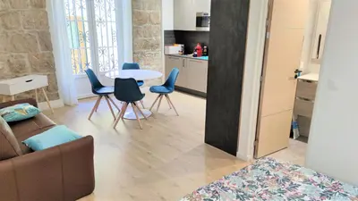 a living room with a couch and a table and chairs at hypercentre lamartine 001 in Nice