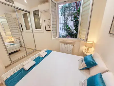 a bedroom with a large white bed and a window at Nestor&Jeeves - MARYLIN - Central - Very close sea in Nice