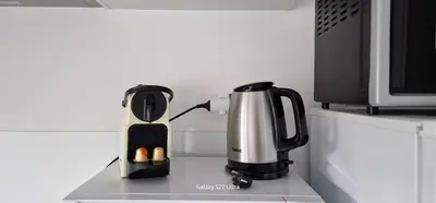 a coffee maker sitting on a counter next to a microwave at HOME ET HOLIDAY Le Petit Manseng in Nice