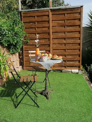 a table with food on it on the grass at Studio Anoe in Nice