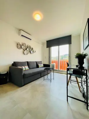 a living room with a couch and a table at Nice Promenade 2 in Nice