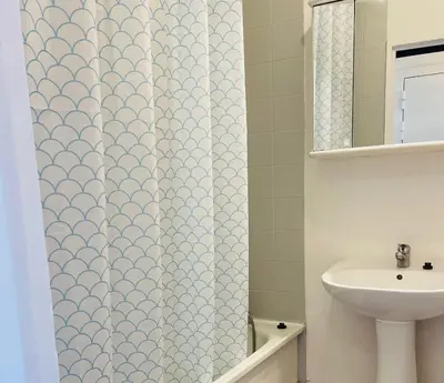 a bathroom with a shower curtain and a sink at Nice Promenade 2 in Nice