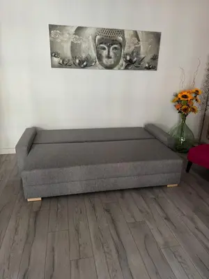 a couch in a room with a vase of flowers at Gorgeous 2 bedrooms holiday apartement in Nice