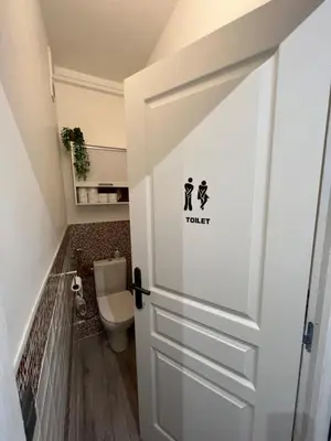 a bathroom with a toilet and a door at Gorgeous 2 bedrooms holiday apartement in Nice