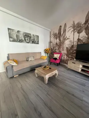 a living room with a couch and a tv and a table at Gorgeous 2 bedrooms holiday apartement in Nice