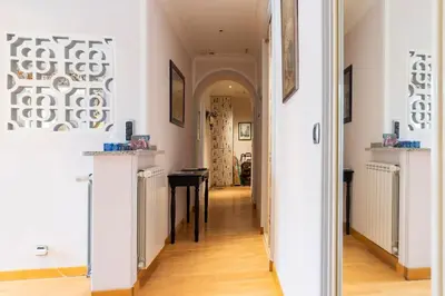 a hallway leading to a room with a table at From 1882, romantic flat, in the Golden Square in Nice